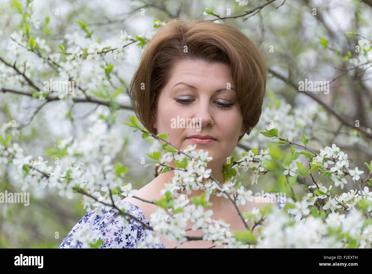Woman with allergic rhinitis in the spring garden Stock Photo