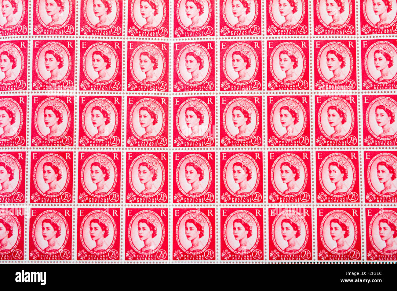 Sheet of 1950's British Royal Mail 2½d red postage stamps from the Wildings definitive issue with portrait of Queen Elizabeth II. Stock Photo
