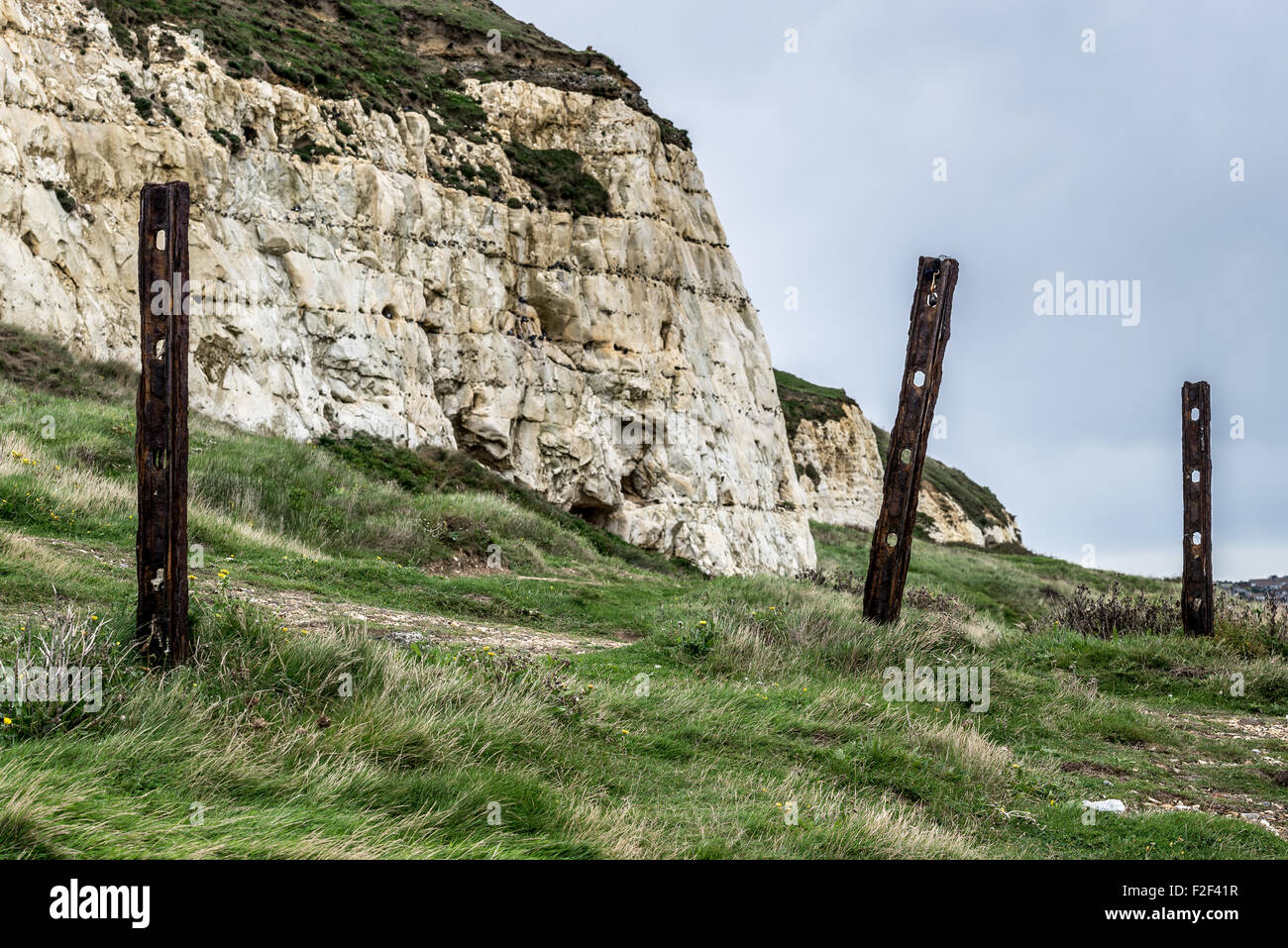 Fence posts in front of chalk cliffs Stock Photo