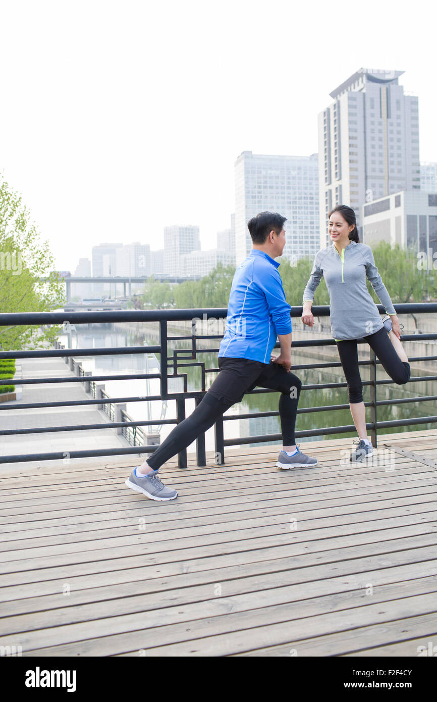 Happy mature couple exercising in park Stock Photo - Alamy