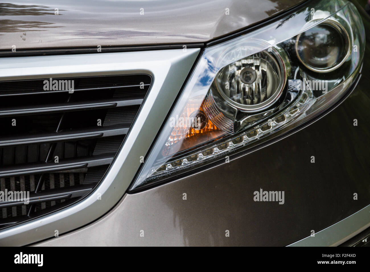Closeup headlights of car. Fast car detail. Stock Photo