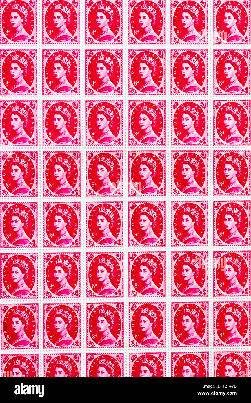 Sheet of 1950's British Royal Mail 8d pink magenta postage stamps from the Wildings definitive issue with portrait of Queen Elizabeth II. Stock Photo