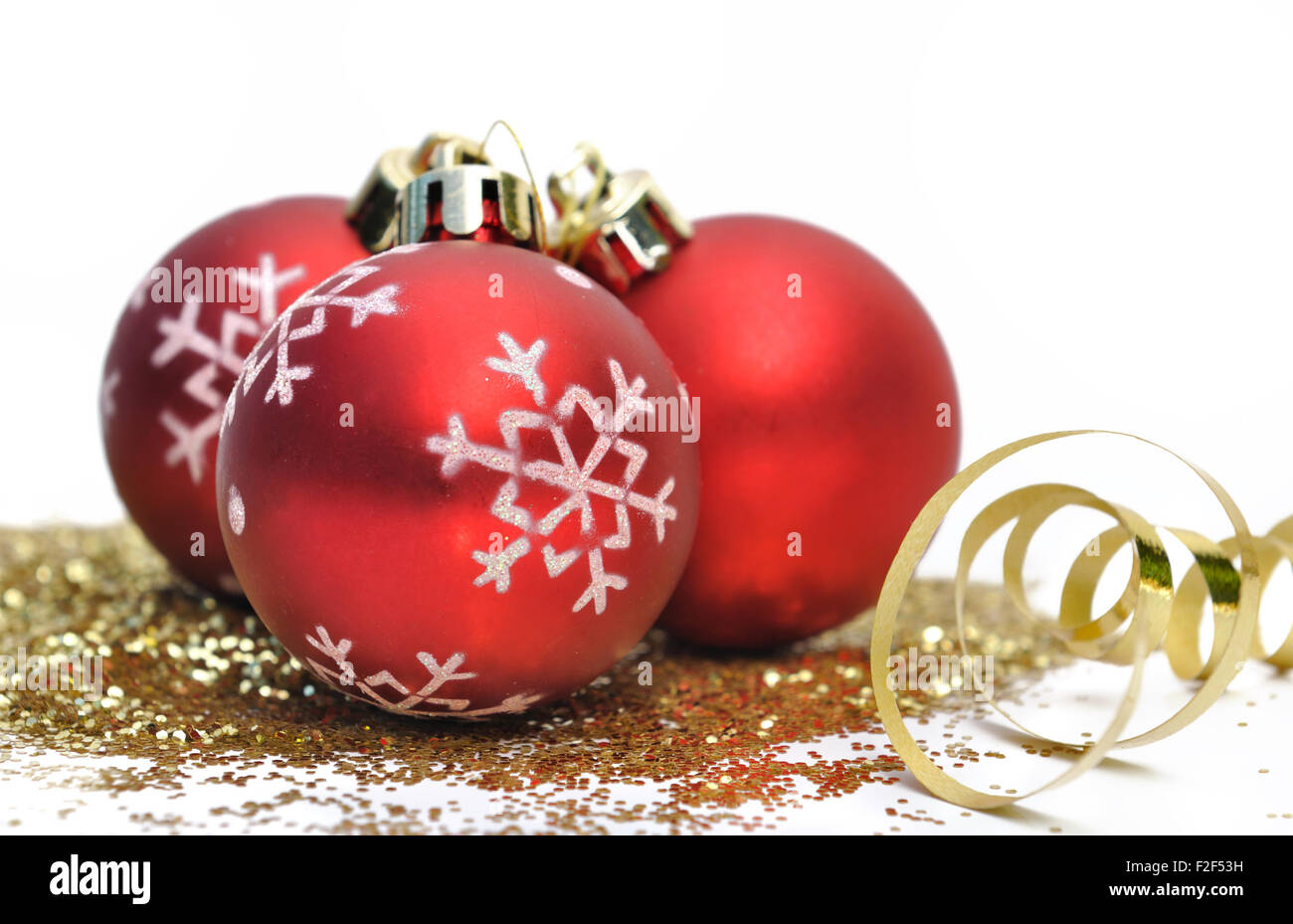 Red christmas balls and gold glitter on white background Stock Photo ...