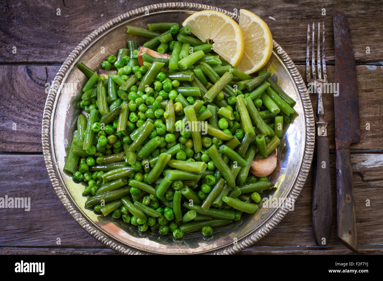 grenn beans and peas on silver old plate Stock Photo Alamy