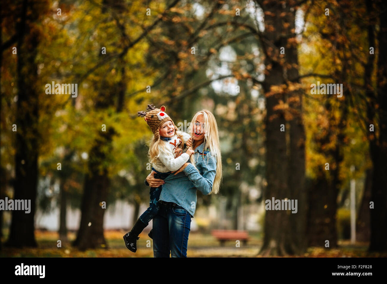 Mother with daughter in autumn park Stock Photo - Alamy