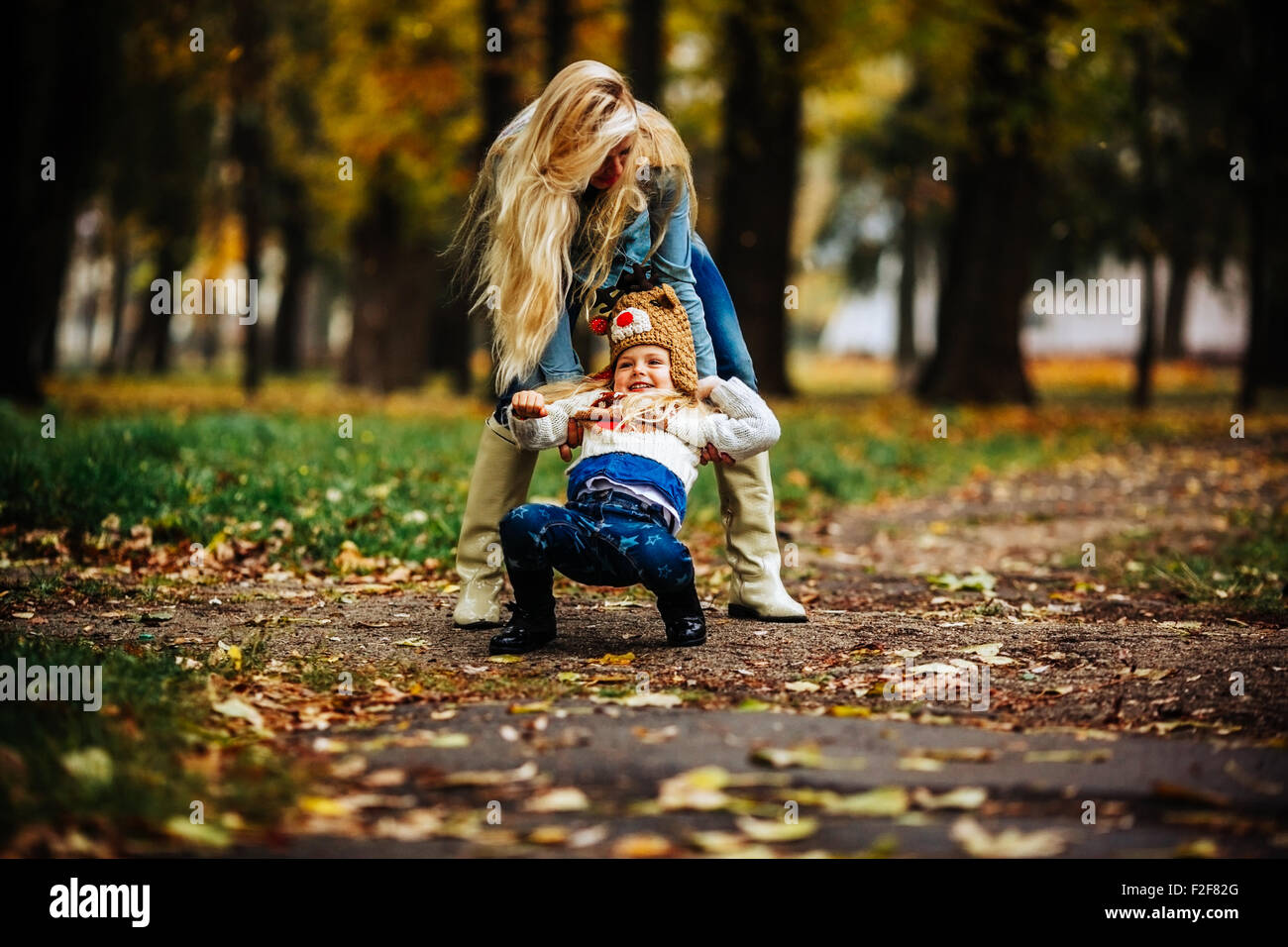 Mother with daughter in autumn park Stock Photo - Alamy