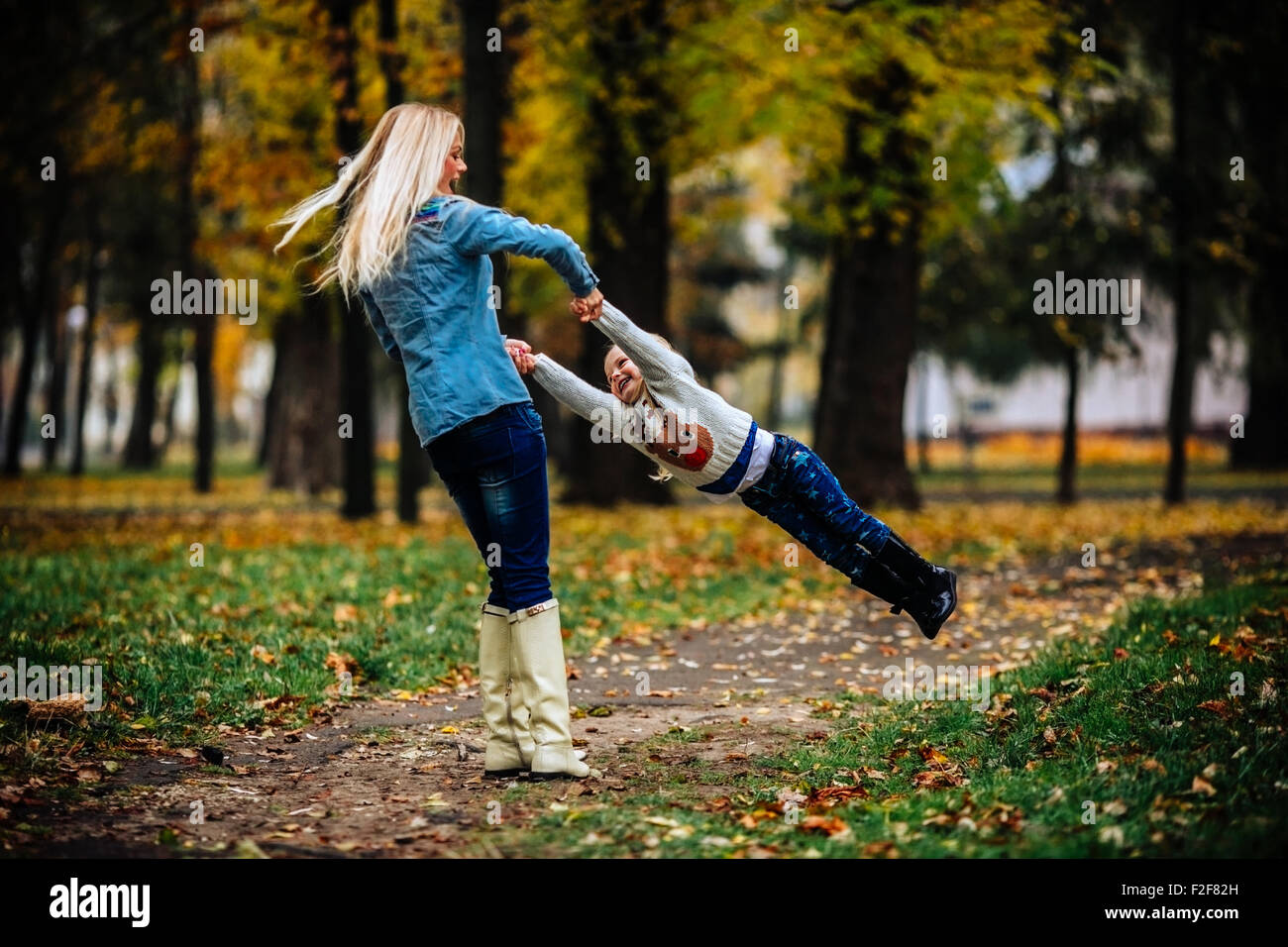 Mother with daughter in autumn park Stock Photo - Alamy