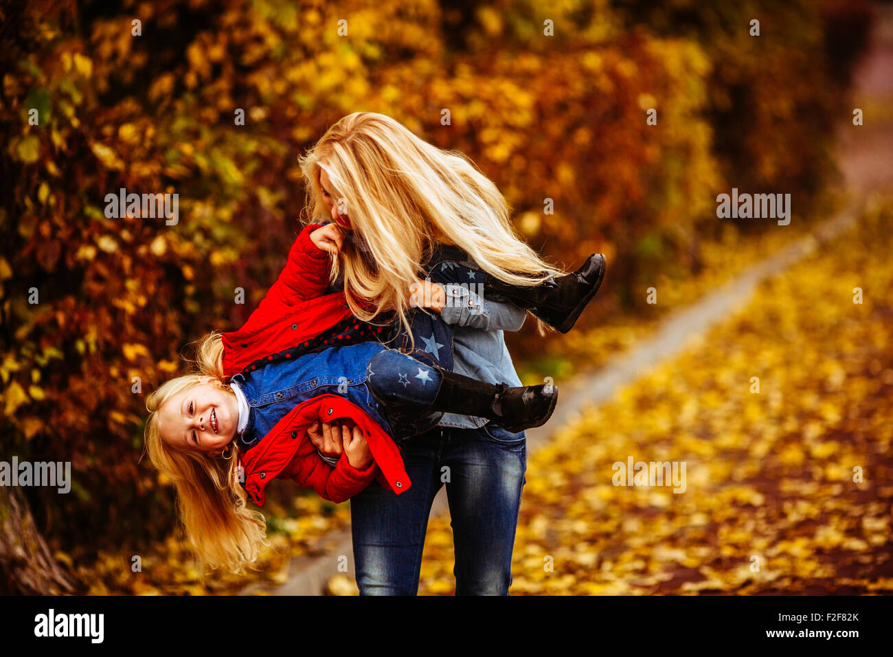 Mother with daughter in autumn park Stock Photo - Alamy