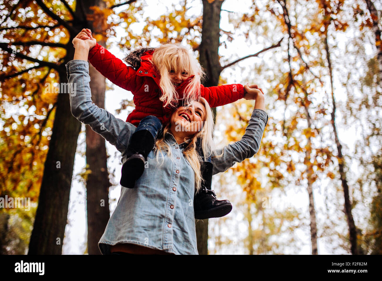 Mother with daughter in autumn park Stock Photo - Alamy