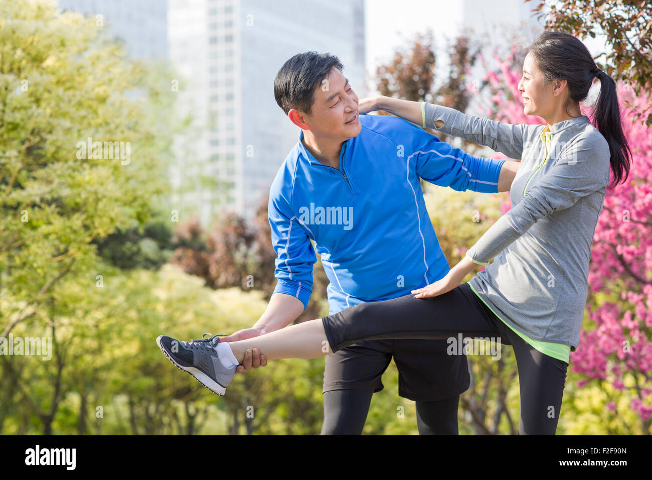 Happy mature couple exercising in park Stock Photo - Alamy