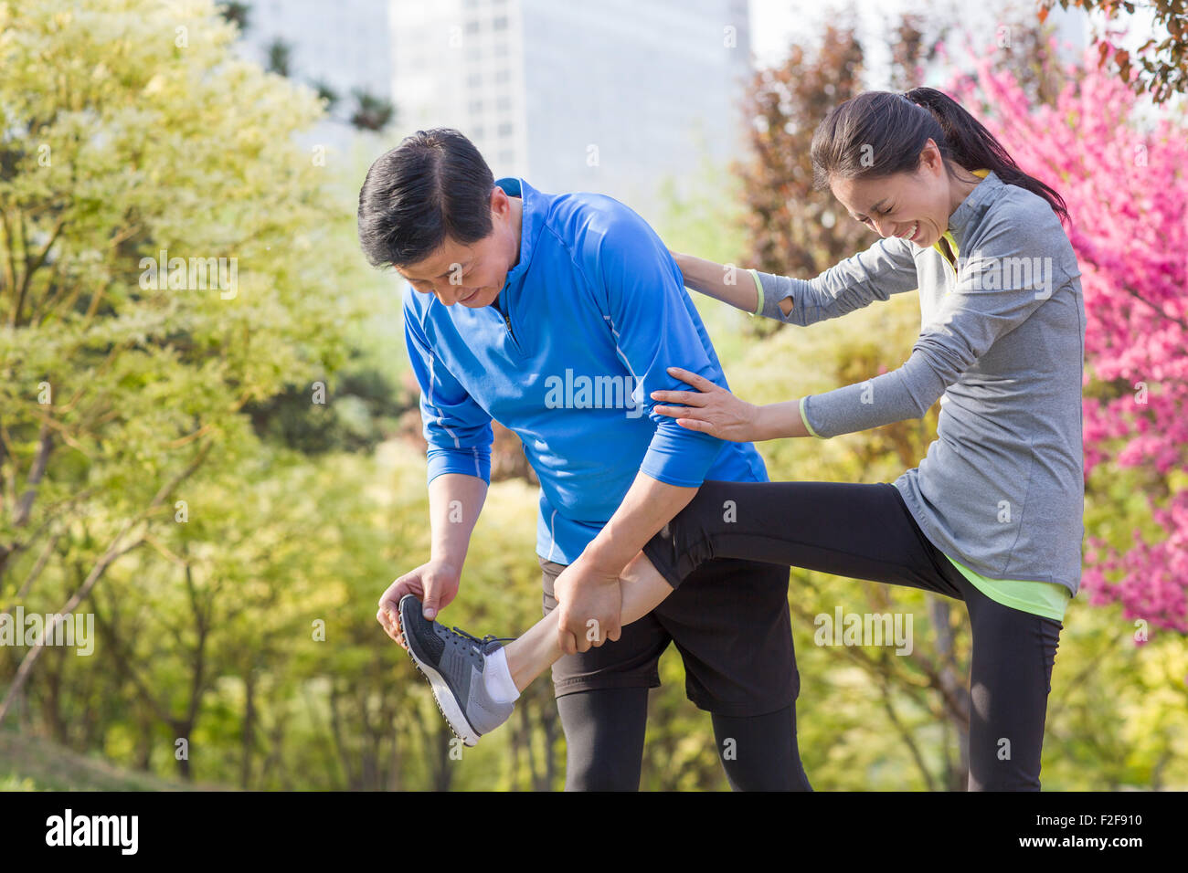 Happy mature couple exercising in park Stock Photo - Alamy