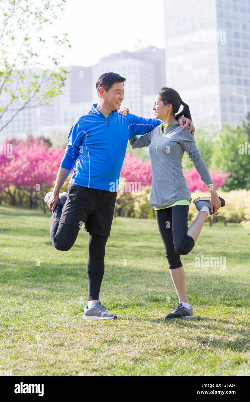 Happy mature couple exercising in park Stock Photo - Alamy
