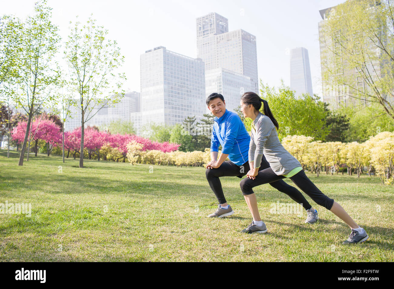 Happy mature couple exercising in park Stock Photo - Alamy