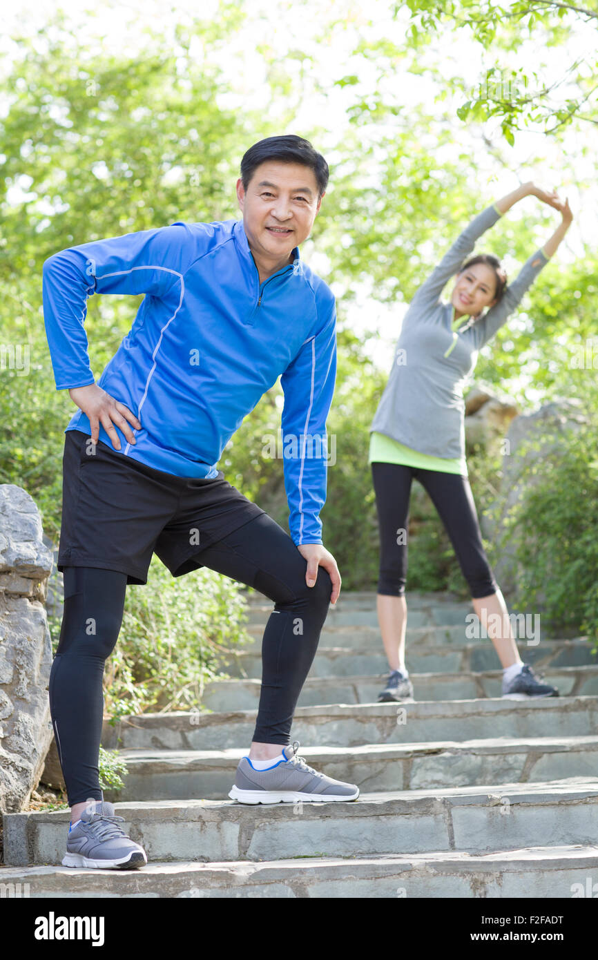 Happy mature couple exercising in park Stock Photo - Alamy