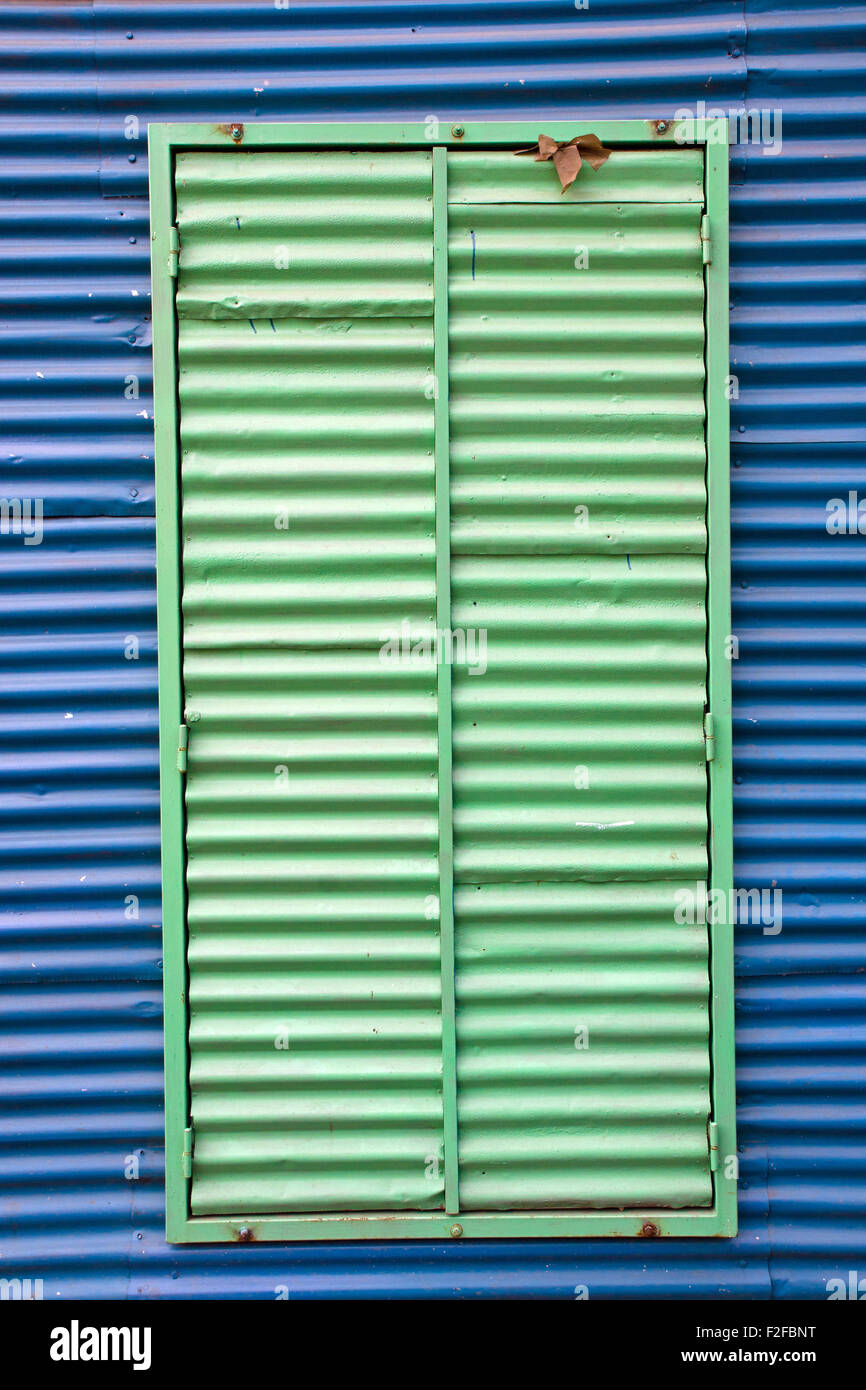 Blue wall with green window in La Boca, Buenos Aires Stock Photo