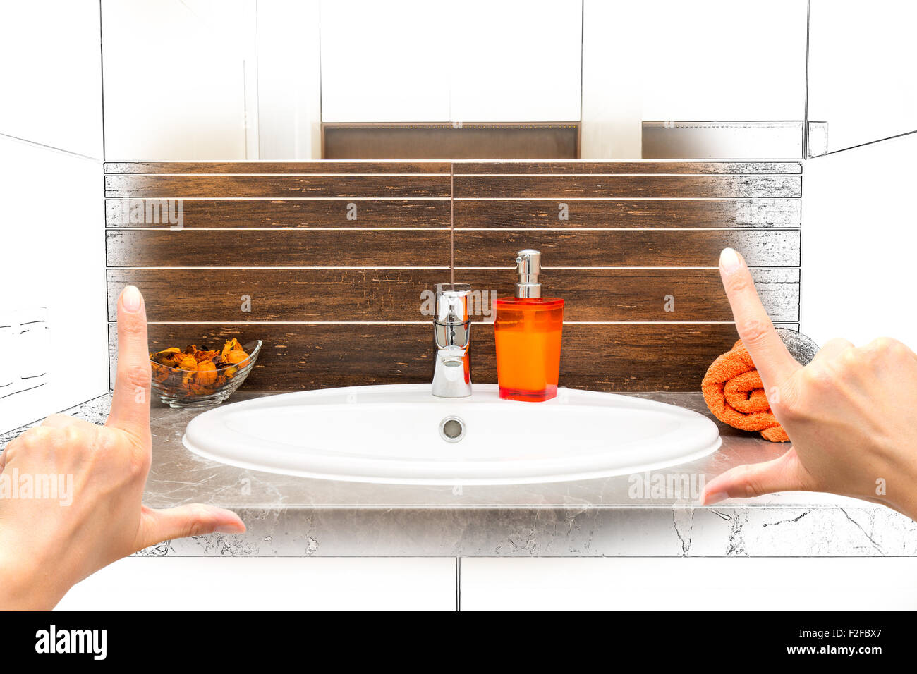 Female hands framing custom bathroom design. Combination drawing and photo. Stock Photo