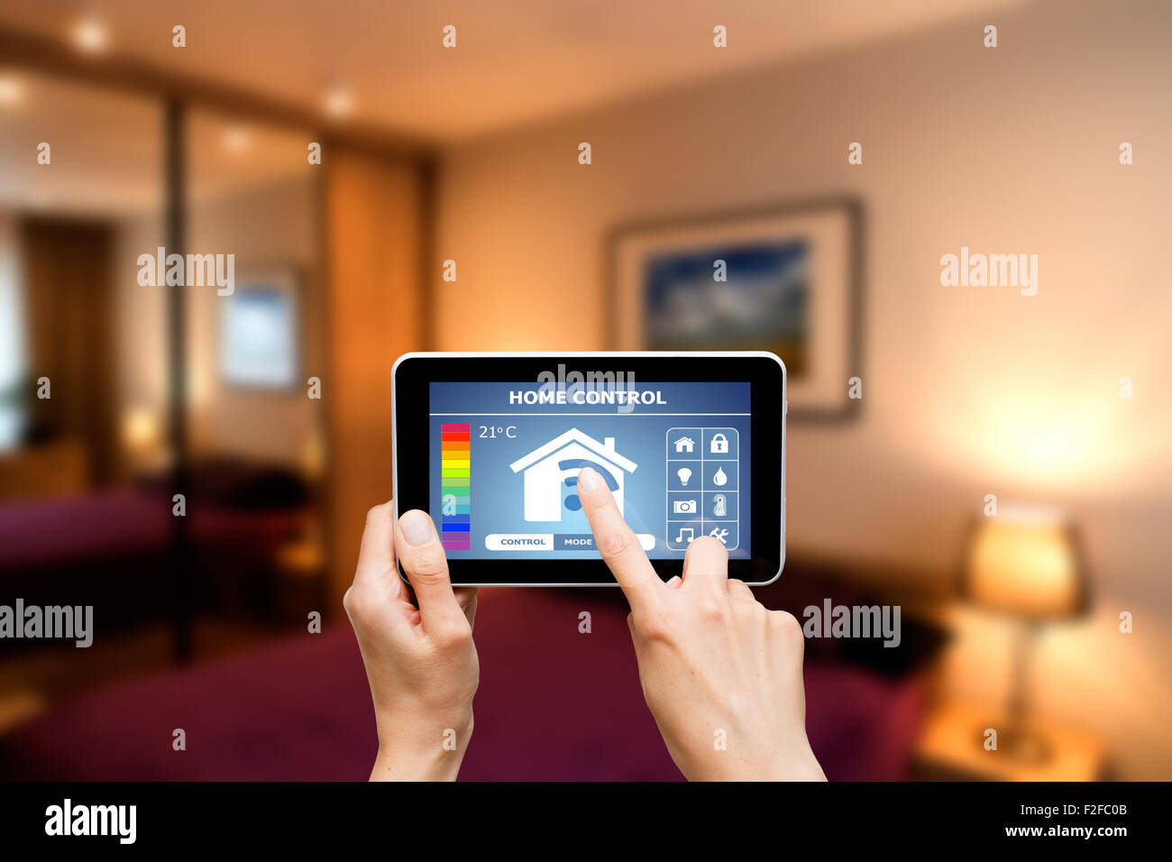 Remote home control system on a digital tablet or phone. Stock Photo