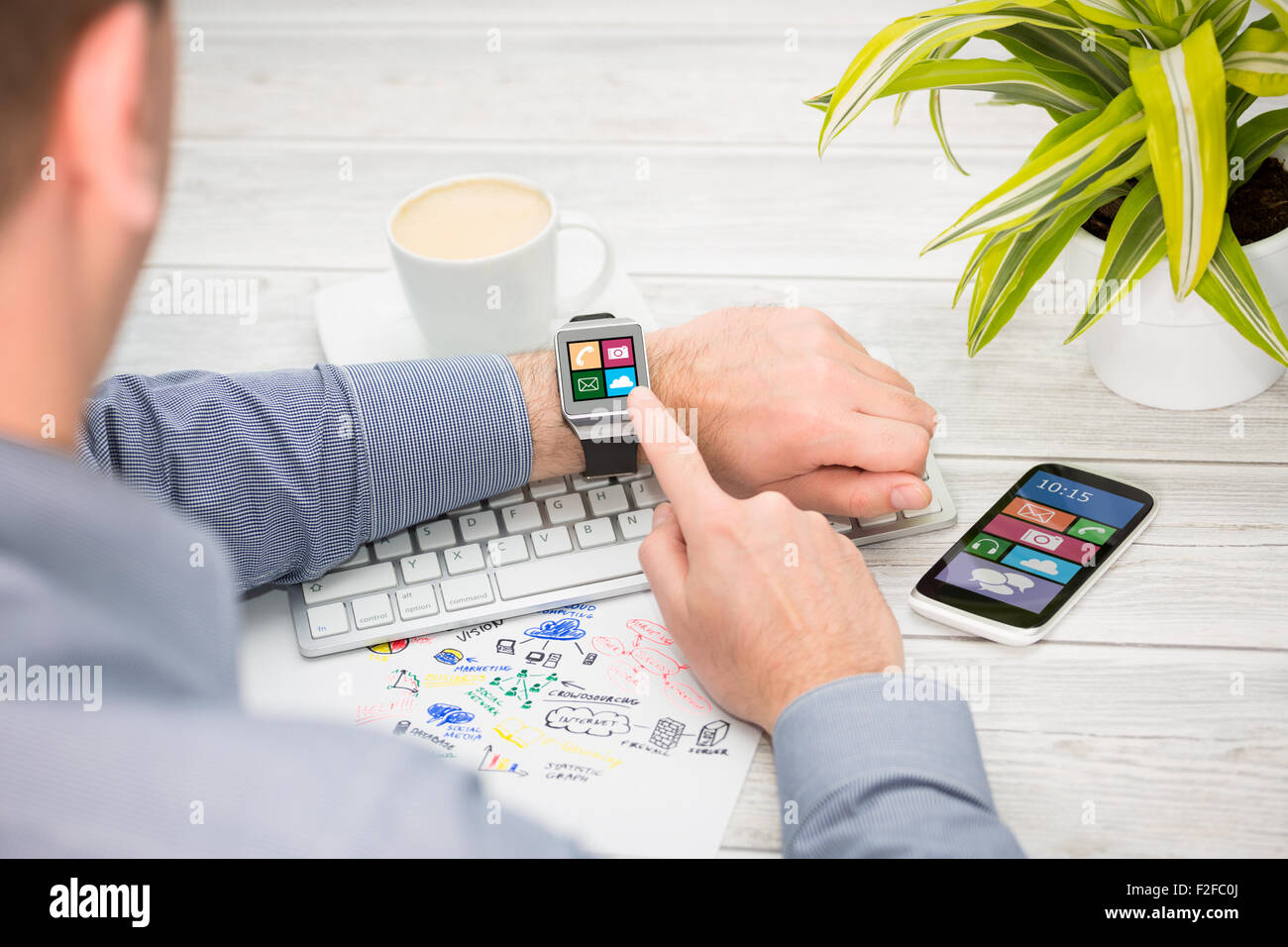 Businessman uses smart watch and phone. Smartwatch concept. Stock Photo