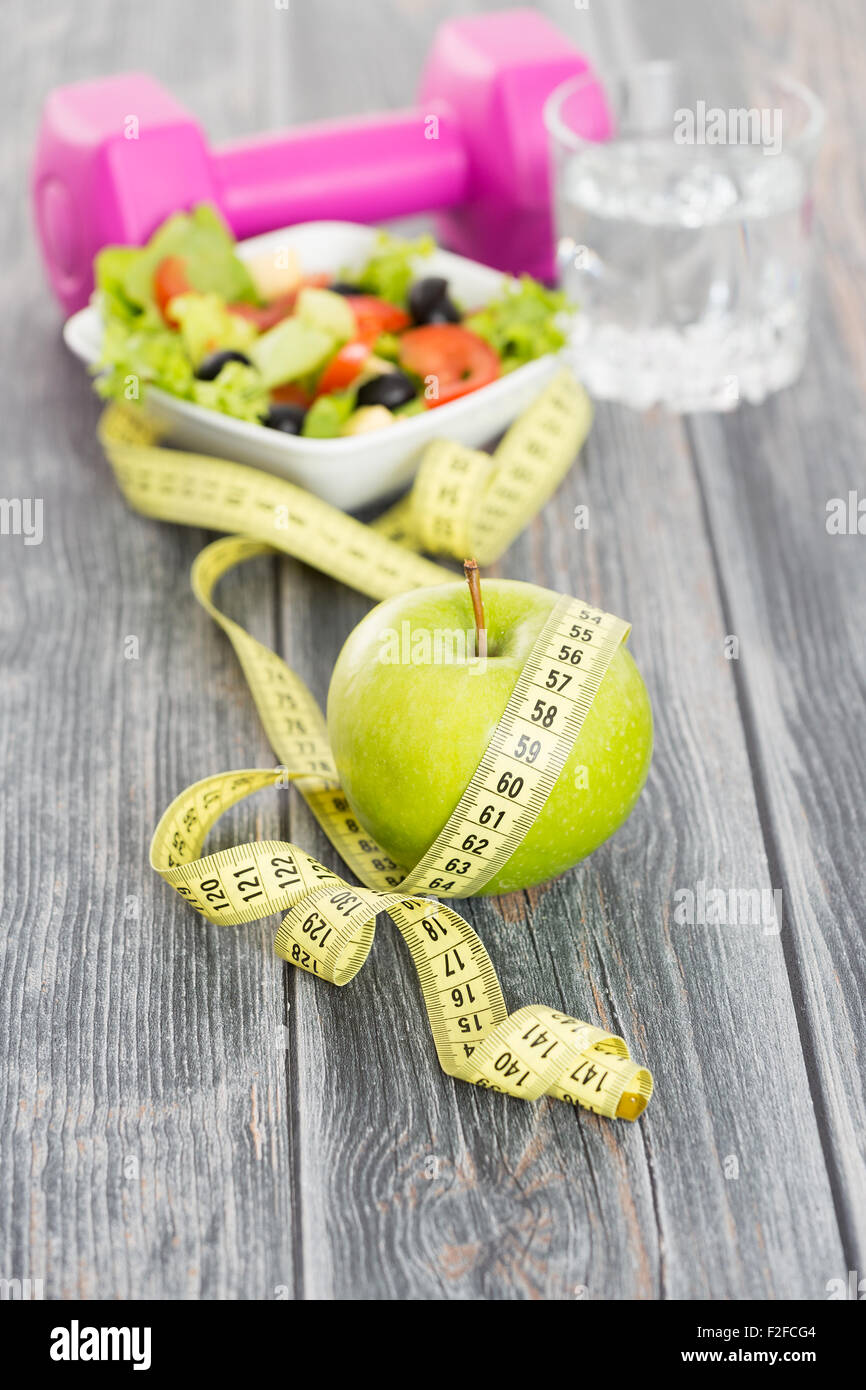 Fitness concept with dumbbells and healthy food. Stock Photo