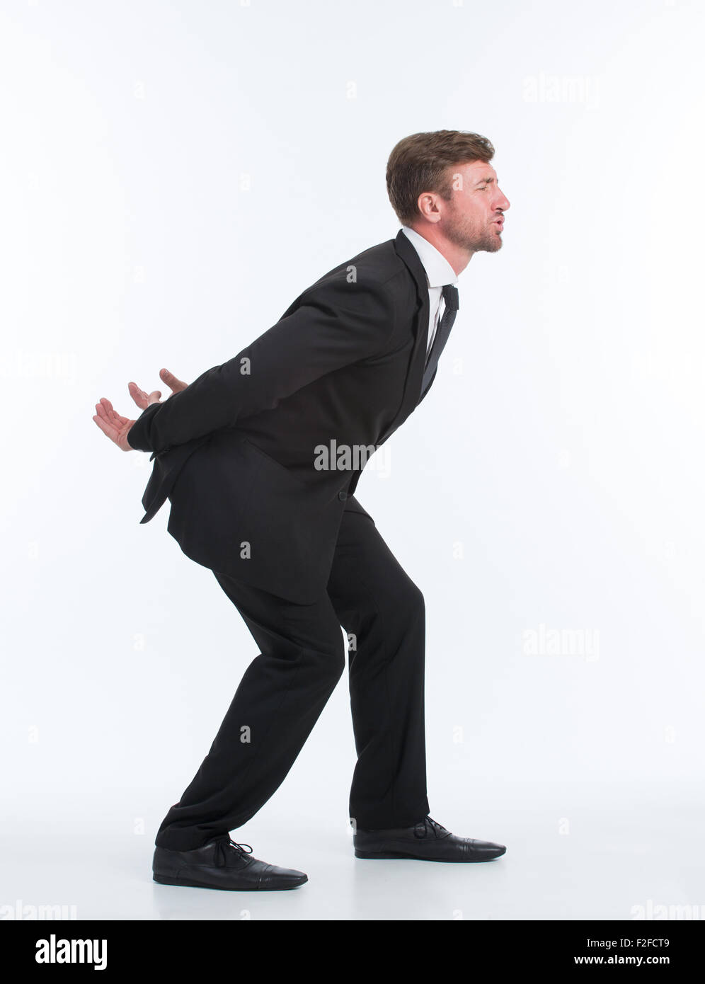 Businessman carrying heavy load on his back Stock Photo Alamy