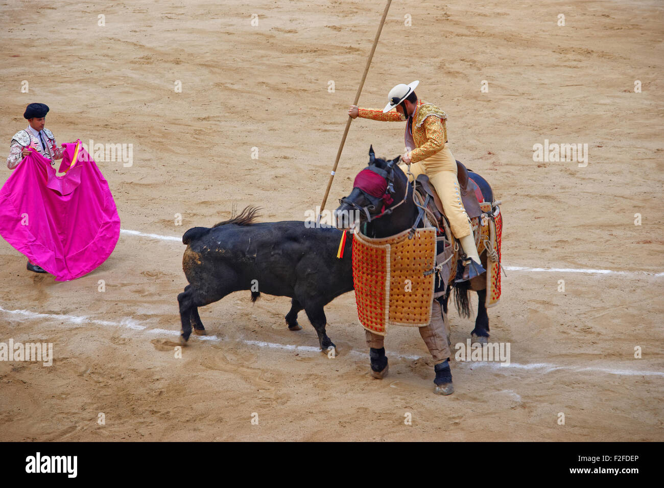 BARCELONA, SPAIN - AUGUST 01, 2010: Bull is attacking the matador (torero) during a bullfight in the Plaza Monumental de Barcelo Stock Photo