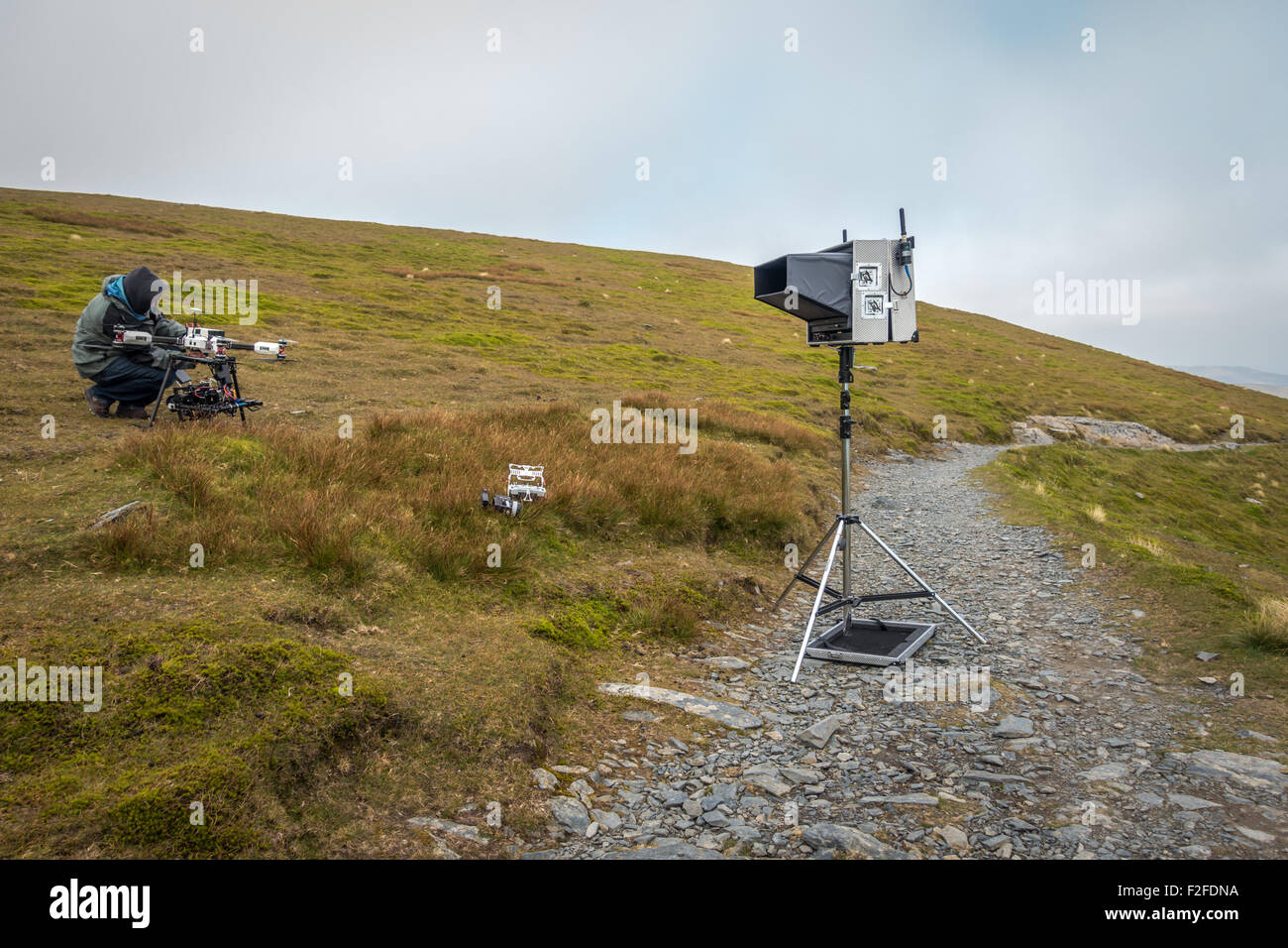 Film crew preparing a large expensive filming drone on the top of a mountain in the Lake District (Blencathra) Stock Photo