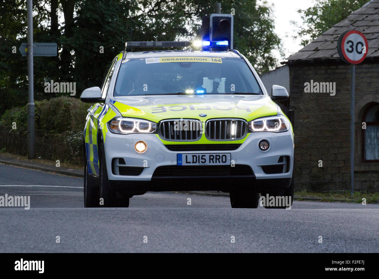 BMW police force officer service policeman pc wpc cop copper law enforcement emergency services policewoman law legal patrol patrolling crime criminal Stock Photo