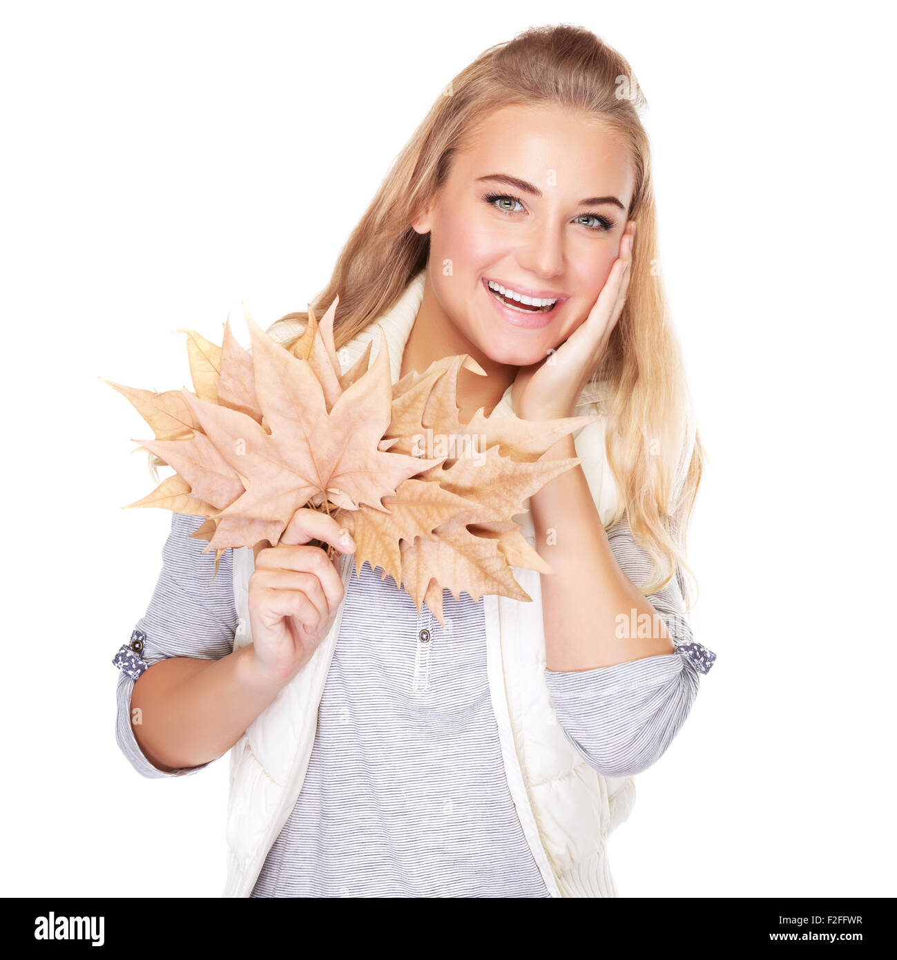 Portrait of beautiful blond woman with dry leaves bouquet isolated on white background, enjoying autumn season Stock Photo