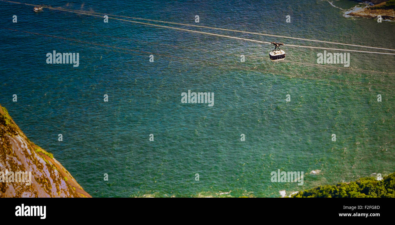 Overhead cable car moving over the ocean, Rio De Janeiro, Brazil Stock Photo