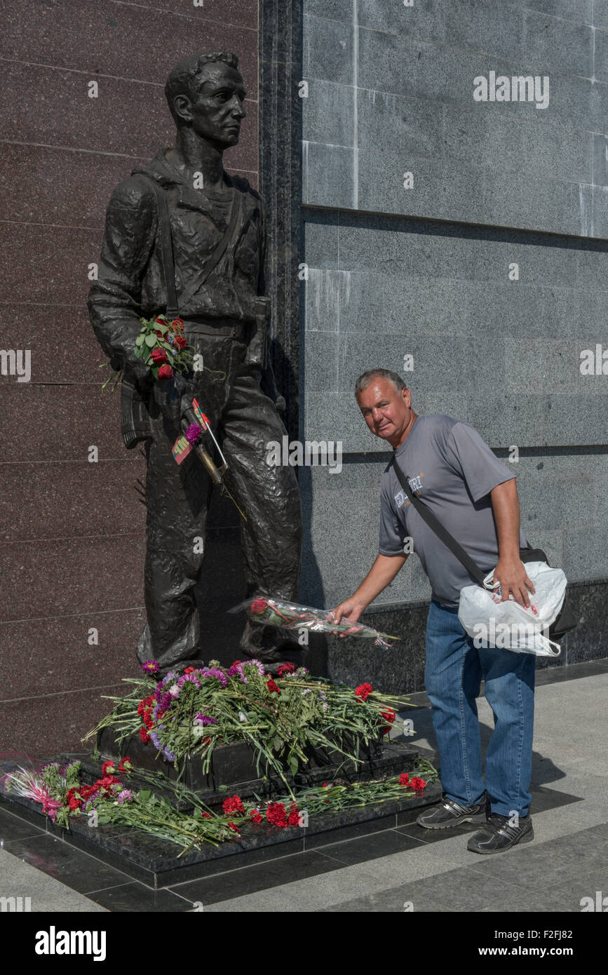 Man Spraying Flowers Memorial - 25th Anniversary of the Pridnestrovian Moldavian Republic PMR, Transnistria, Soviet USSR Moldova Stock Photo