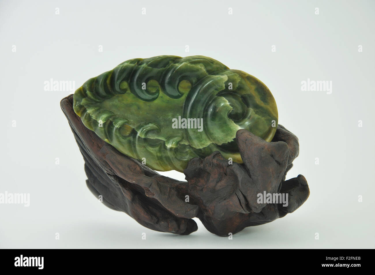 Jade carving set on a driftwood display stand, West Coast, South Island