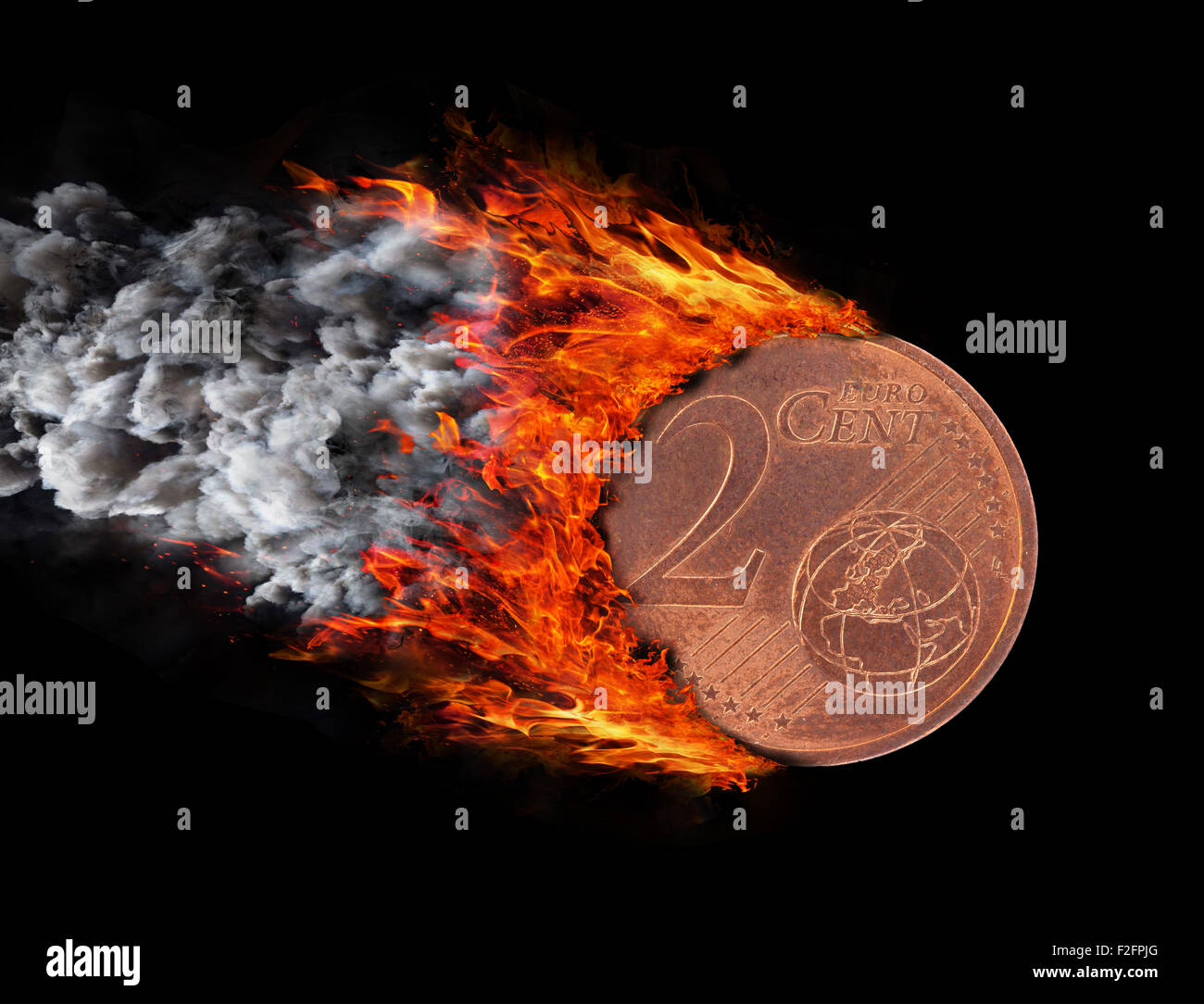 Burning coin with a trail of fire and smoke - 2 eurocent Stock Photo