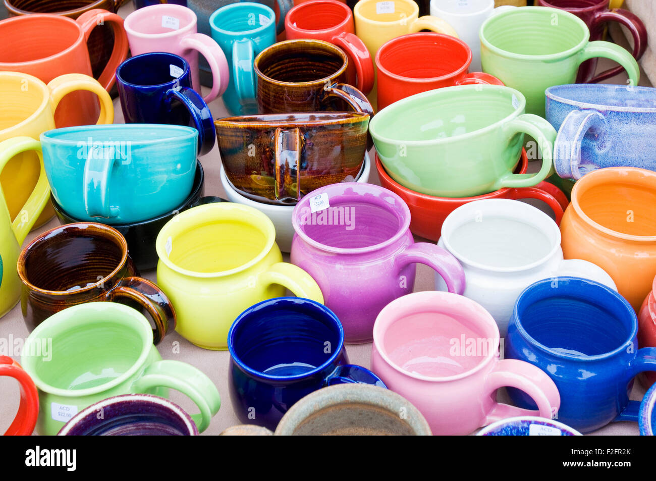 Colorful mugs on sale at a farmers and craft market Stock Photo