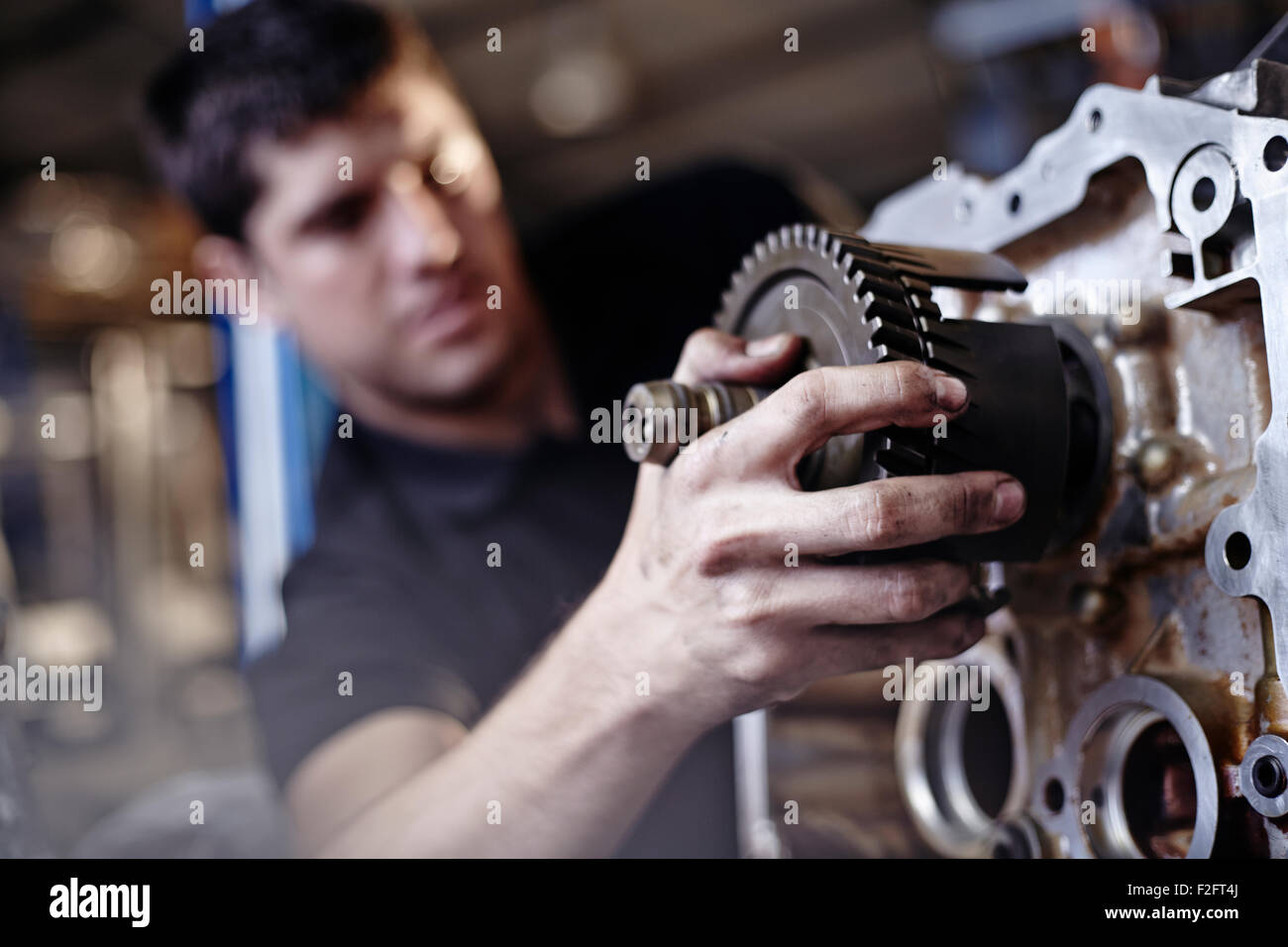 Close up mechanic fixing part in auto repair shop Stock Photo