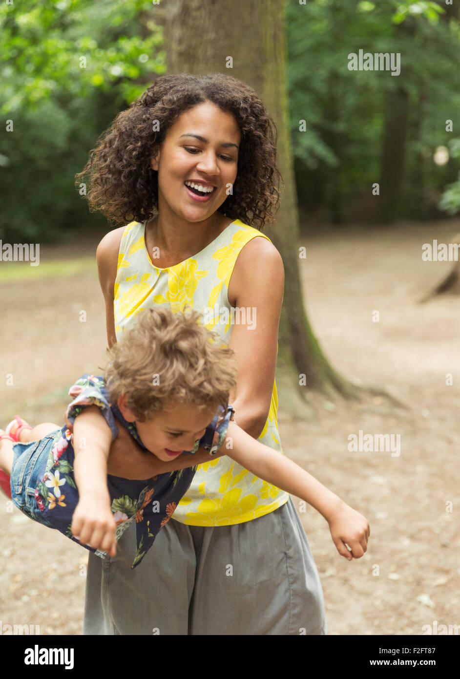 Playful mother flying son Stock Photo