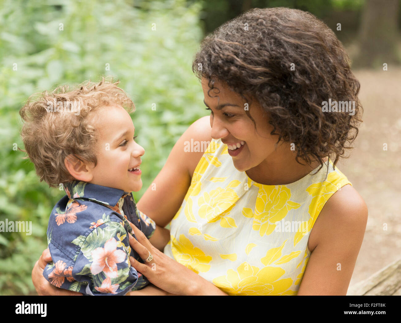 Smiling mother and son face to face Stock Photo