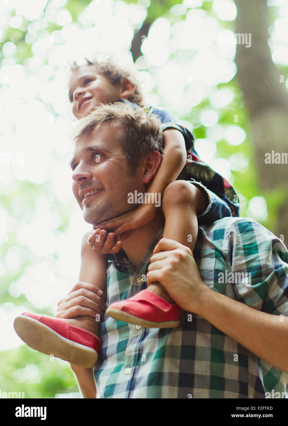 Father carrying son on shoulders Stock Photo