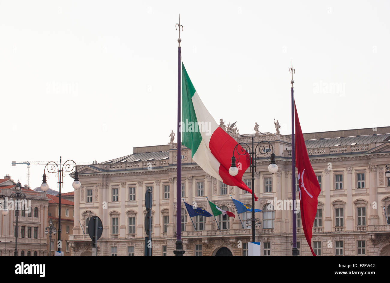 View of Italian and Trieste flags blowing in the wind Stock Photo