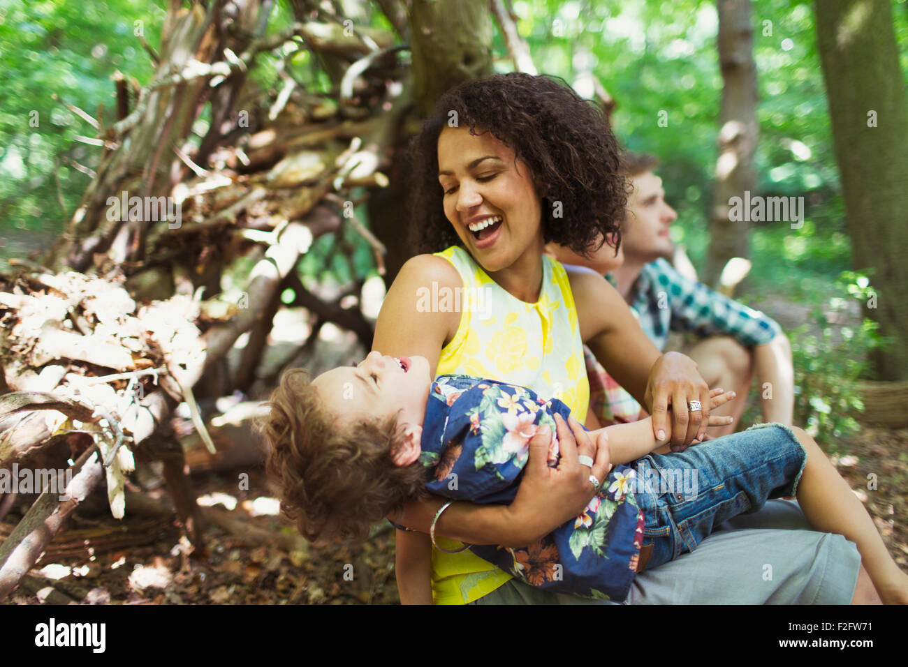 Playful mother and son in woods Stock Photo