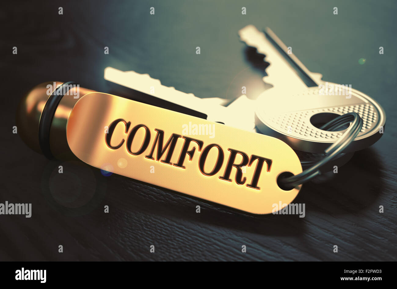 Comfort - Bunch of Keys with Text on Golden Keychain. Black Wooden Background. Closeup View with Selective Focus. 3D Illustratio Stock Photo