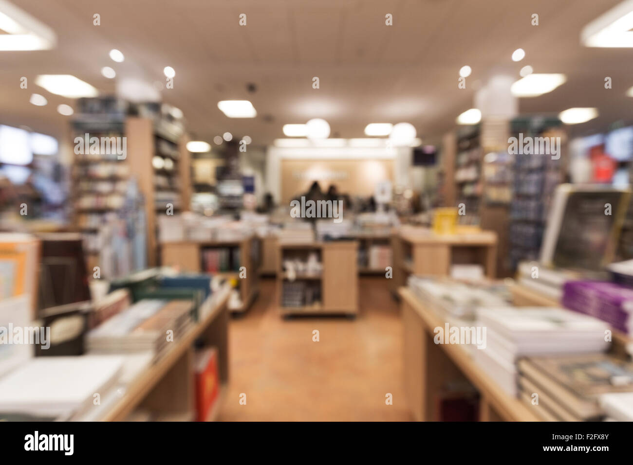 Out of focus shot from a book store, looking down the store towards the counter with customers standing by it. Great for use as Stock Photo
