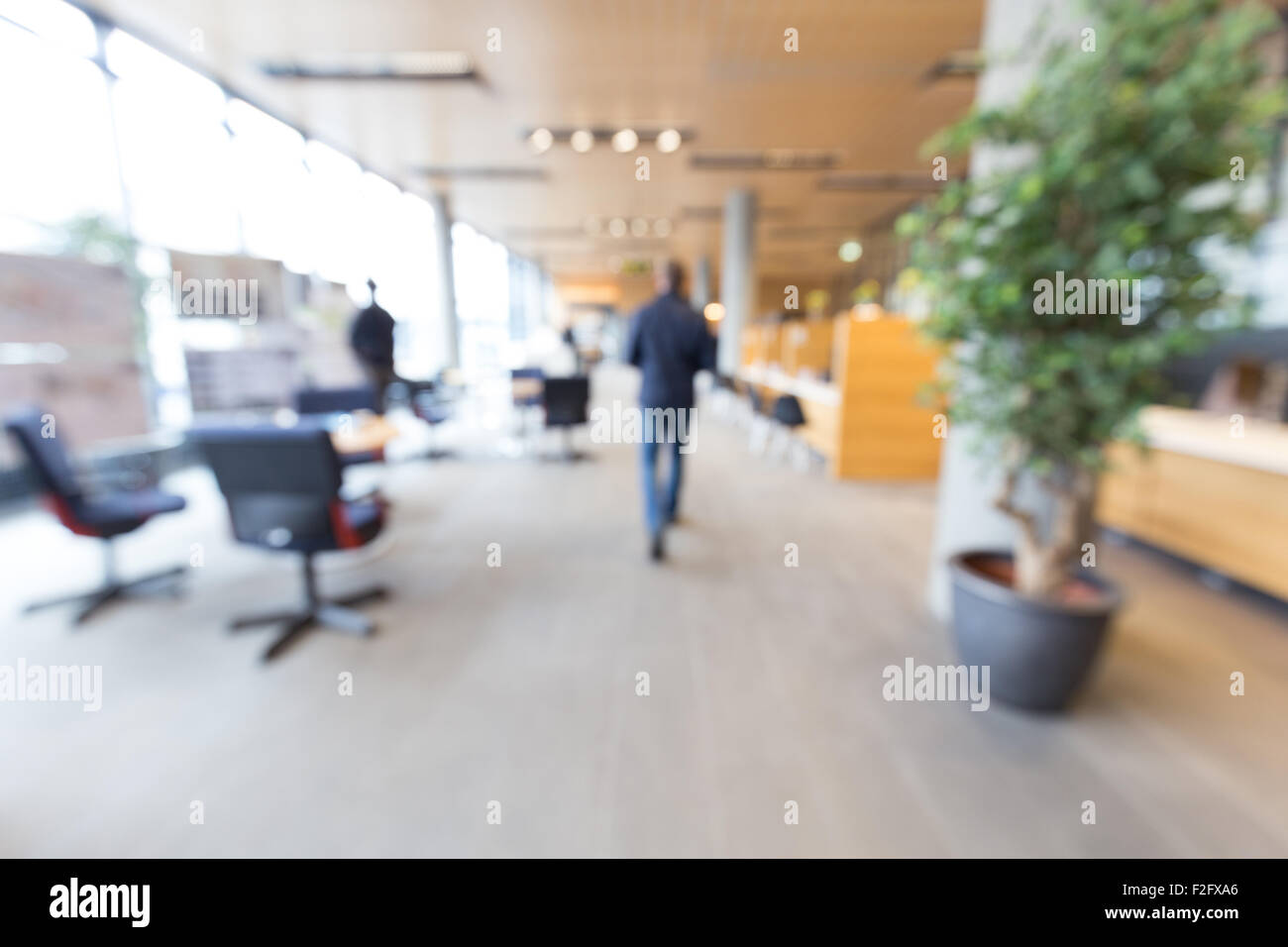Out of focus shot of a man walking into a generic service center Stock Photo