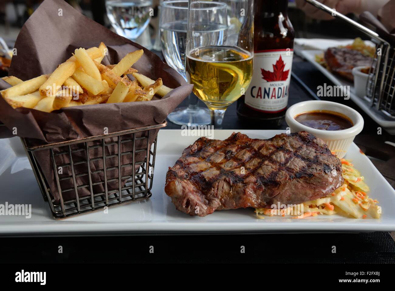 Barbecued Alberta ribeye steak, salad and chips in a basket at the