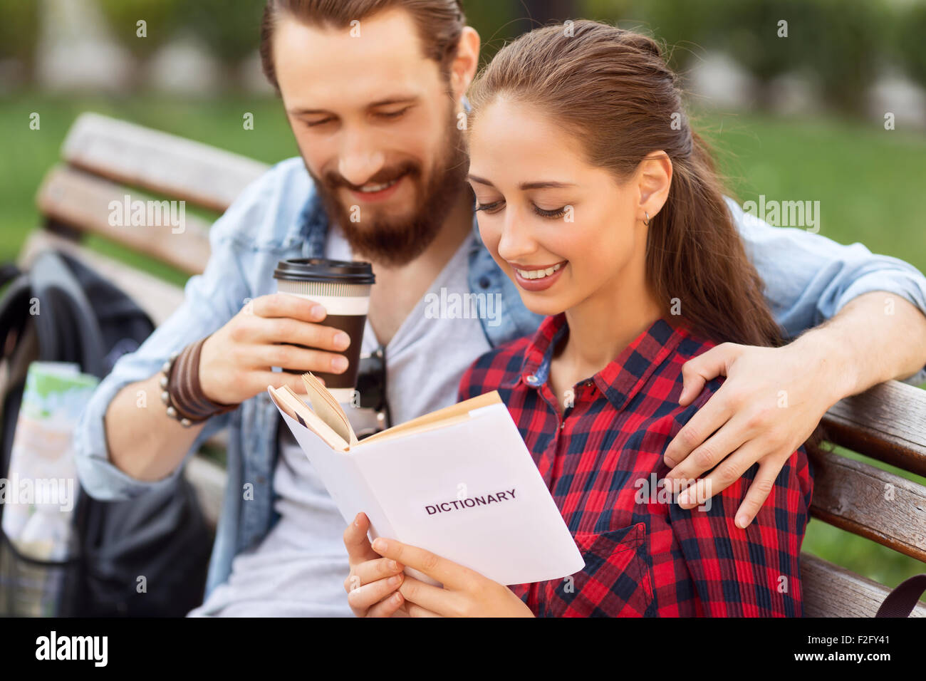 Happy couple sitting on the bench Stock Photo - Alamy