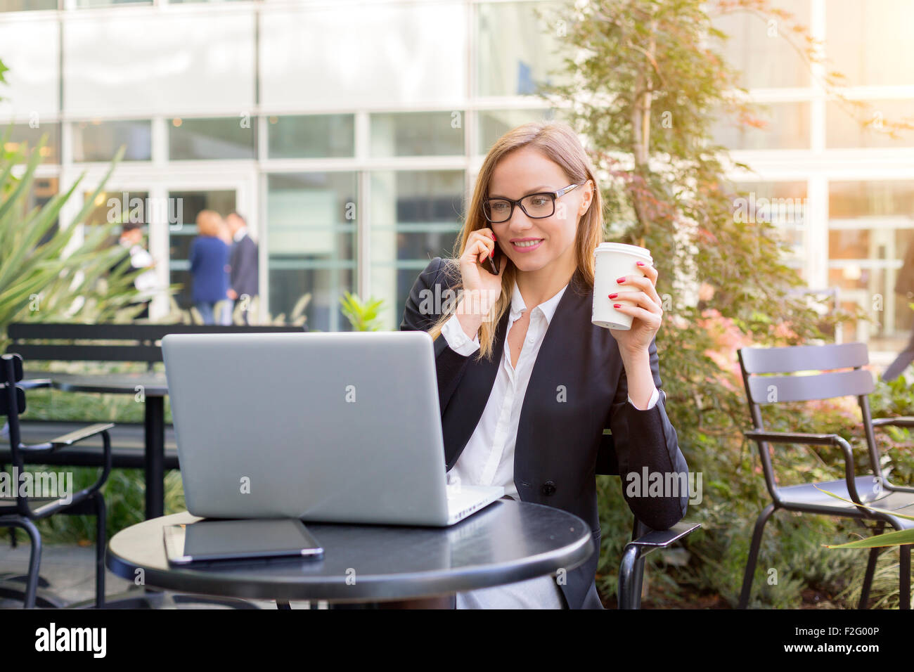 Businesswoman having a coffee break Stock Photo - Alamy