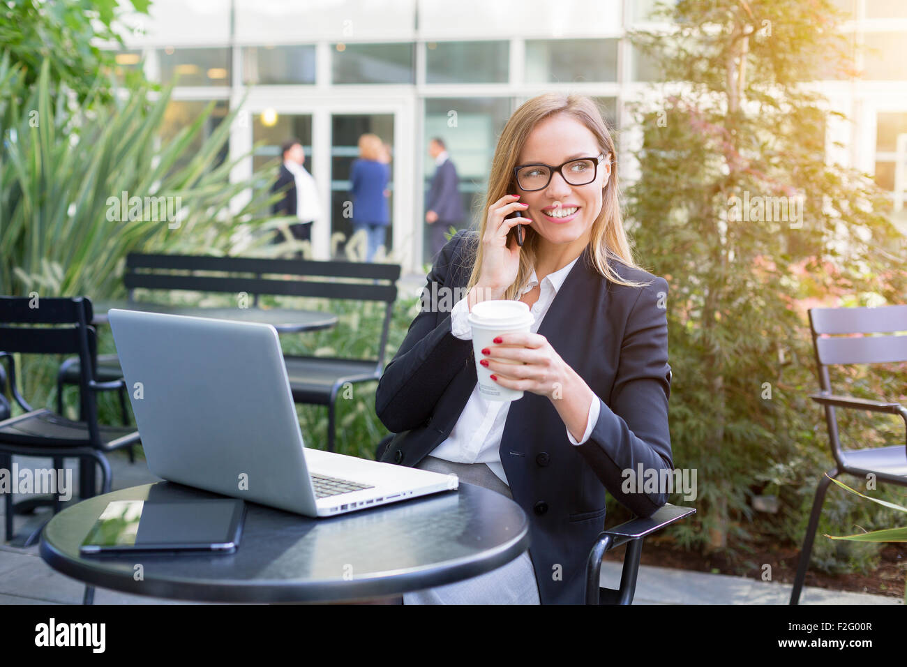 Businesswoman having a coffee break Stock Photo - Alamy