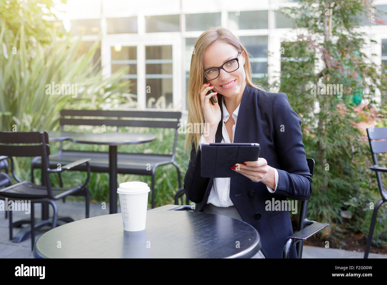 Businesswoman having a coffee break Stock Photo - Alamy