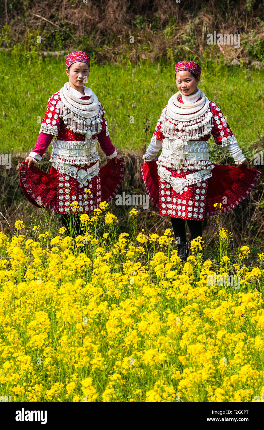 Young Miao women wearing traditional costumes and silver jewellery, Yunnan, China Stock Photo