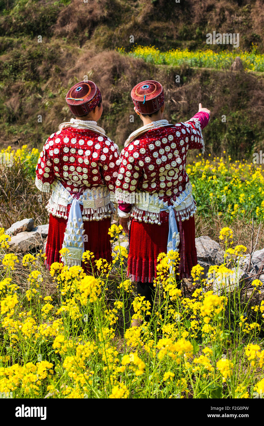 Young Miao women wearing traditional costumes and silver jewellery, Yunnan, China Stock Photo