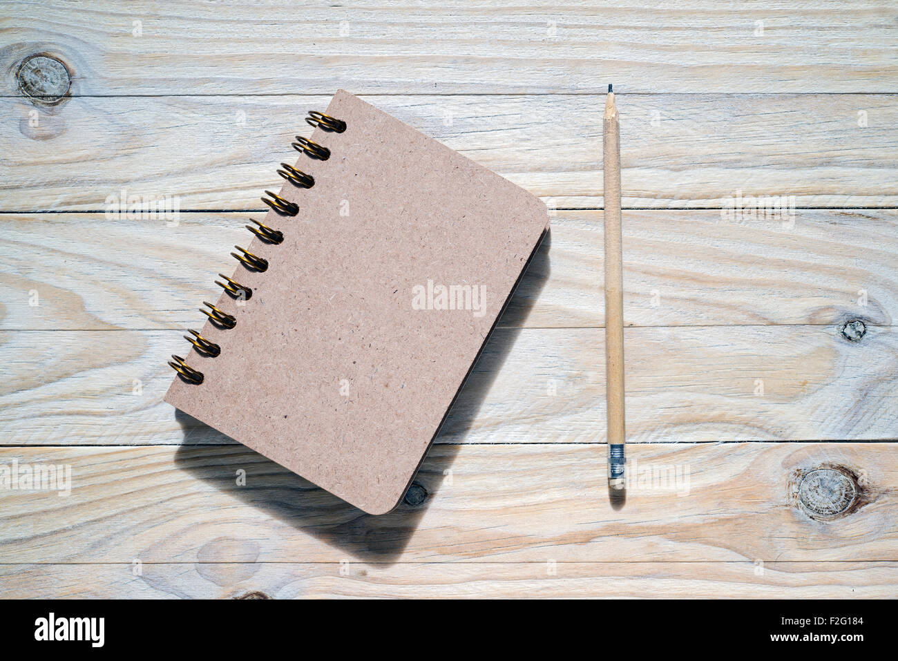 pen and notebook on wooden table Stock Photo
